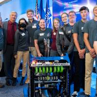 FIRST robotics students and their robot